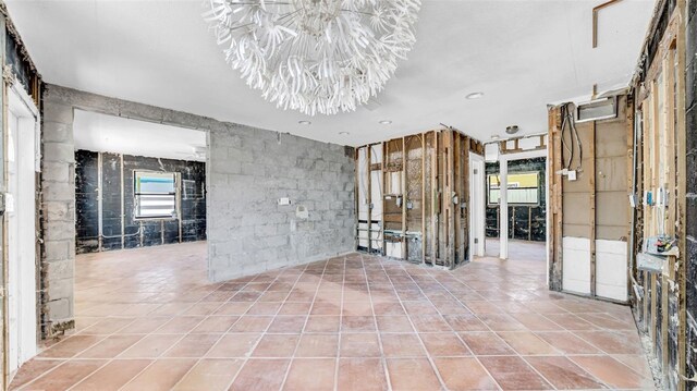 121 86th Ter, Treasure Island, FL 33706 - empty room featuring a chandelier and tile patterned flooring