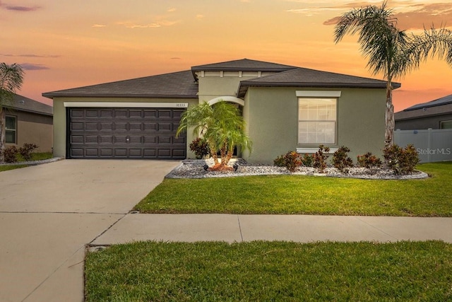 10333 Scarlet Skimmer Dr, Riverview, FL 33578 - view of front facade featuring stucco siding, an attached garage, concrete driveway, and roof with shingles