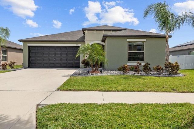 10333 Scarlet Skimmer Dr, Riverview, FL 33578 - view of front of house with stucco siding, a garage, concrete driveway, and roof with shingles