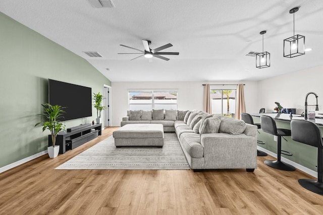 10333 Scarlet Skimmer Dr, Riverview, FL 33578 - living room featuring vaulted ceiling, a ceiling fan, and wood finished floors