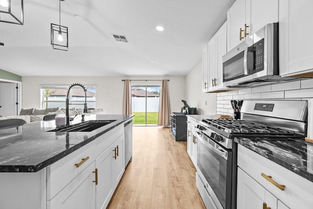 10333 Scarlet Skimmer Dr, Riverview, FL 33578 - kitchen featuring stainless steel appliances, light wood-type flooring, white cabinetry, plenty of natural light, and recessed lighting