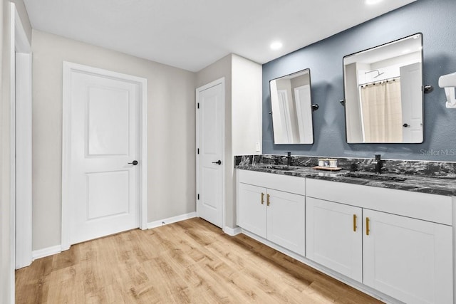 10333 Scarlet Skimmer Dr, Riverview, FL 33578 - bathroom with double vanity, wood finished floors, and recessed lighting