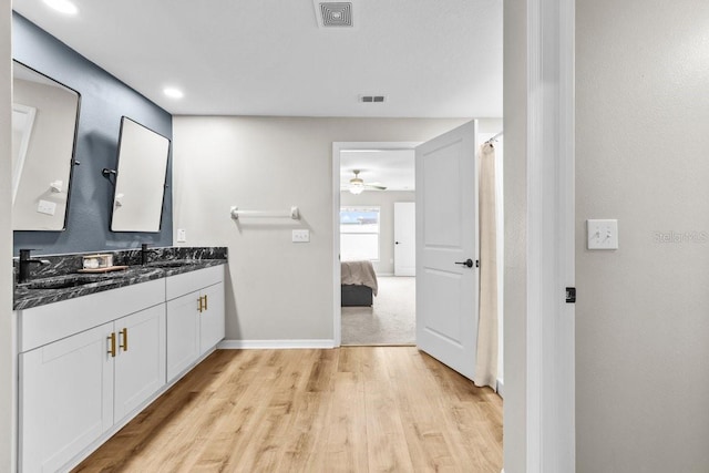 10333 Scarlet Skimmer Dr, Riverview, FL 33578 - ensuite bathroom featuring wood finished floors, double vanity, and ceiling fan