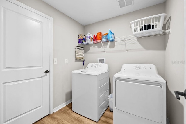 10333 Scarlet Skimmer Dr, Riverview, FL 33578 - laundry room featuring washing machine and clothes dryer and wood finished floors