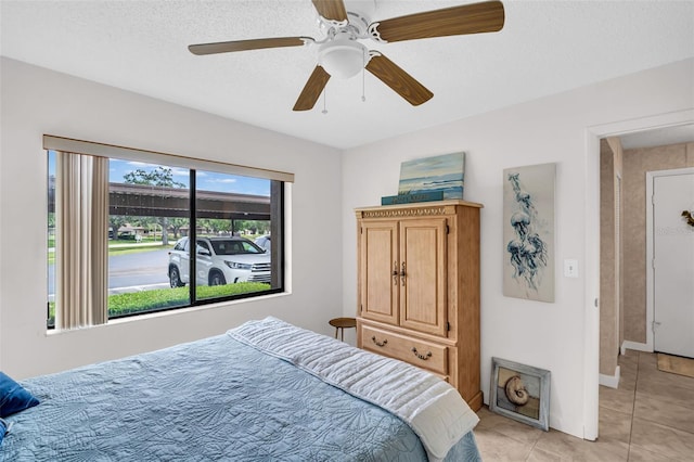 2506 Laurelwood Dr Unit 4C, Clearwater, FL 33763 - bedroom featuring baseboards, a ceiling fan, and light tile patterned flooring