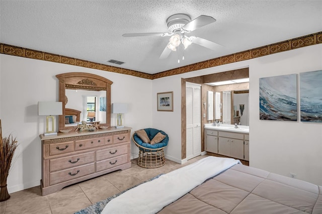 2506 Laurelwood Dr Unit 4C, Clearwater, FL 33763 - bedroom with light tile patterned floors, a textured ceiling, visible vents, and a sink