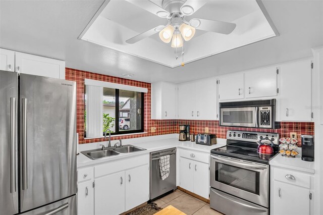 2506 Laurelwood Dr Unit 4C, Clearwater, FL 33763 - kitchen with ceiling fan, a sink, light countertops, stainless steel appliances, and a tray ceiling