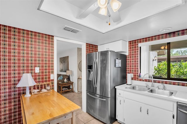 2506 Laurelwood Dr Unit 4C, Clearwater, FL 33763 - kitchen featuring appliances with stainless steel finishes, a sink, light countertops, light tile patterned floors, and visible vents