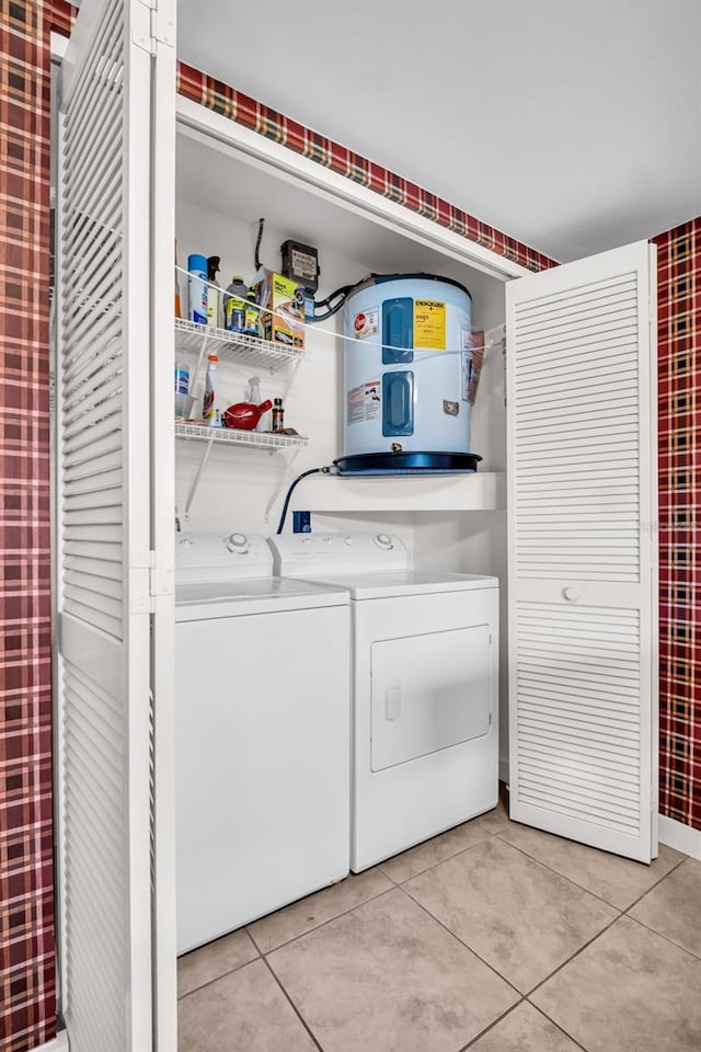 2506 Laurelwood Dr Unit 4C, Clearwater, FL 33763 - clothes washing area featuring water heater, light tile patterned floors, laundry area, and washer and dryer