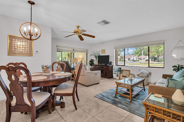 2506 Laurelwood Dr Unit 4C, Clearwater, FL 33763 - dining area with visible vents, light tile patterned floors, and ceiling fan with notable chandelier