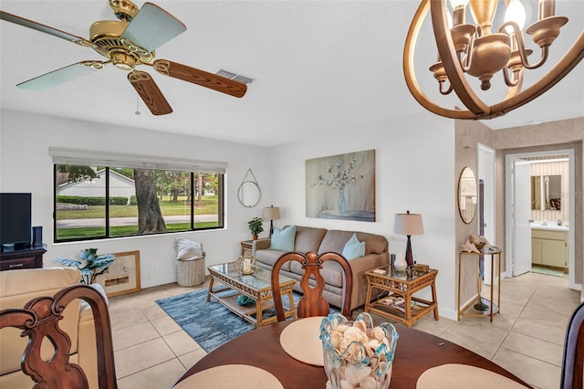 2506 Laurelwood Dr Unit 4C, Clearwater, FL 33763 - living room featuring visible vents, baseboards, ceiling fan with notable chandelier, and light tile patterned flooring