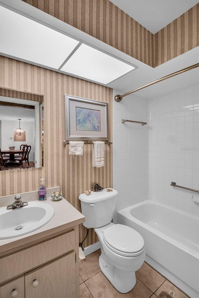 2506 Laurelwood Dr Unit 4C, Clearwater, FL 33763 - bathroom with tile patterned floors, washtub / shower combination, toilet, and wallpapered walls