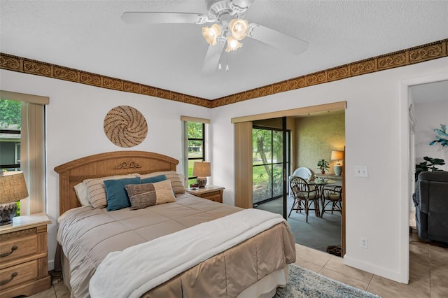 2506 Laurelwood Dr Unit 4C, Clearwater, FL 33763 - bedroom with a textured ceiling, multiple windows, a ceiling fan, and light tile patterned flooring
