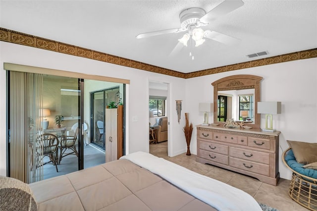 2506 Laurelwood Dr Unit 4C, Clearwater, FL 33763 - bedroom with a ceiling fan, a textured ceiling, visible vents, access to exterior, and light tile patterned flooring