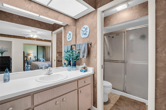 2506 Laurelwood Dr Unit 4C, Clearwater, FL 33763 - full bath featuring vanity, toilet, connected bathroom, a ceiling fan, and a stall shower