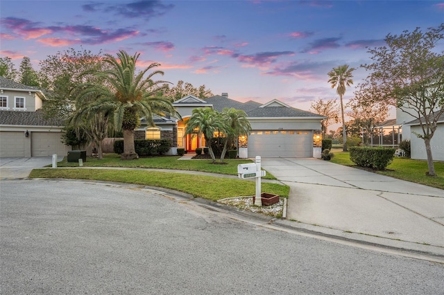 view of front of home featuring stucco siding, a front yard, concrete driveway, and an attached garage