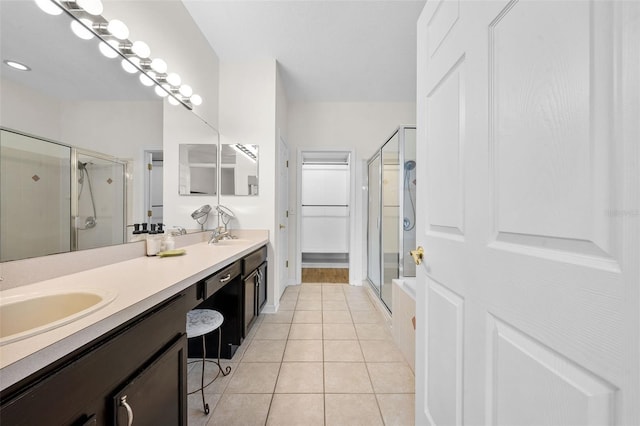 full bath with a shower stall, tile patterned flooring, double vanity, and a sink