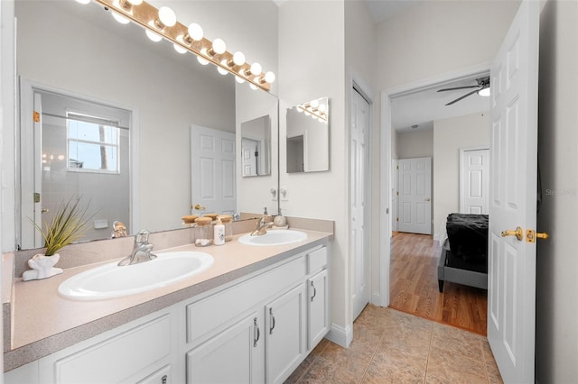 bathroom featuring double vanity, tile patterned floors, a ceiling fan, and a sink