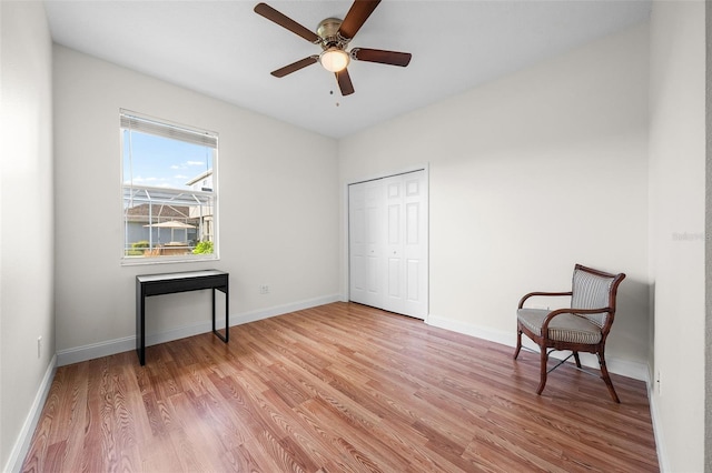 unfurnished room featuring ceiling fan, light wood-style flooring, and baseboards