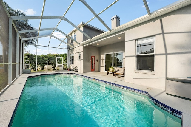 outdoor pool with a patio and glass enclosure
