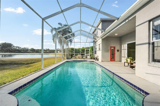 outdoor pool featuring a yard, a patio, a water view, and glass enclosure