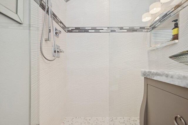 full bathroom with walk in shower and vanity