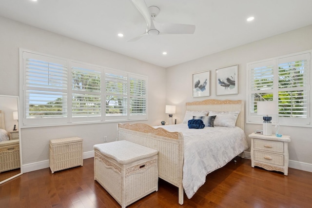bedroom featuring baseboards, recessed lighting, wood finished floors, and multiple windows