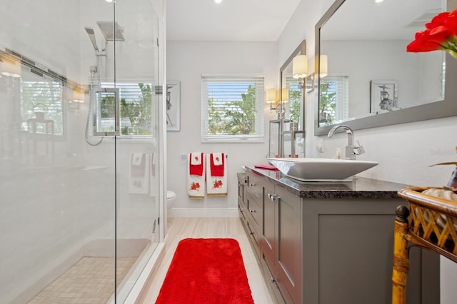 bathroom with visible vents, a stall shower, toilet, and vanity