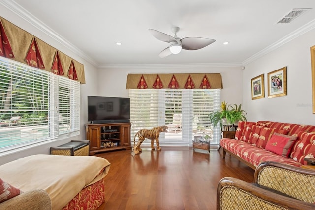 living area featuring ornamental molding, visible vents, and plenty of natural light