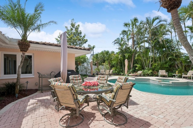 view of swimming pool featuring a patio and a pool with connected hot tub