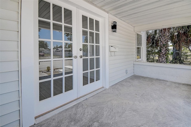 exterior space featuring a porch and french doors