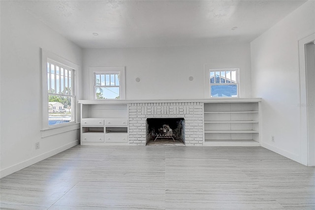unfurnished living room with wood finished floors and baseboards