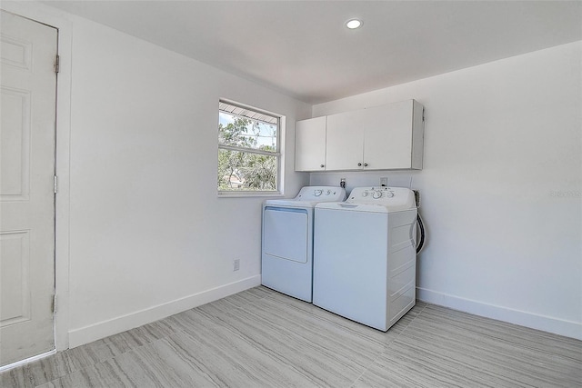 clothes washing area featuring baseboards, recessed lighting, cabinet space, and washing machine and dryer