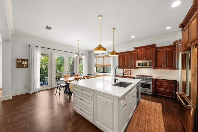 kitchen featuring decorative backsplash, dark wood-style flooring, high quality appliances, light countertops, and a sink