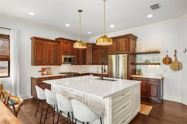 kitchen with a sink, baseboards, stainless steel appliances, and visible vents