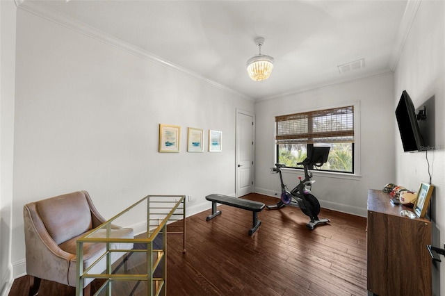 exercise area featuring crown molding, visible vents, wood finished floors, baseboards, and a notable chandelier