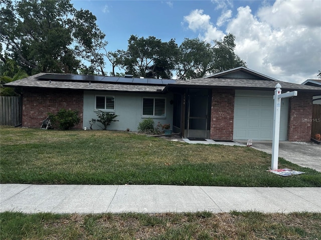 2154 Briarway Dr, Clearwater, FL 33763 - ranch-style house featuring an attached garage, brick siding, roof mounted solar panels, and driveway