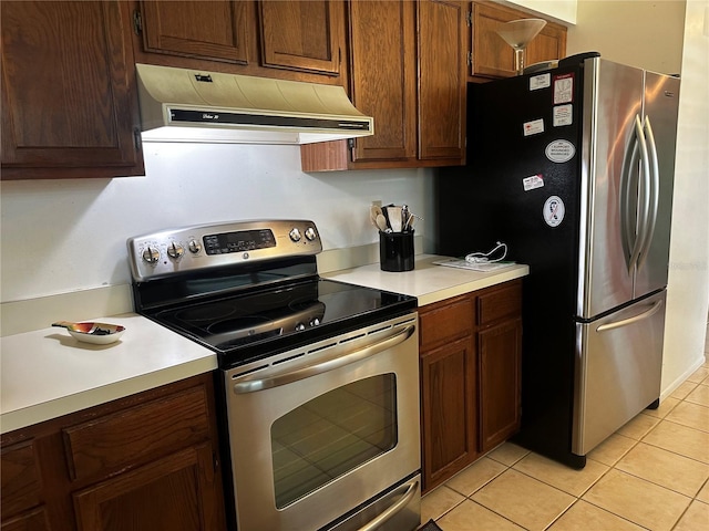2154 Briarway Dr, Clearwater, FL 33763 - kitchen with stainless steel appliances, custom exhaust hood, light countertops, and light tile patterned flooring