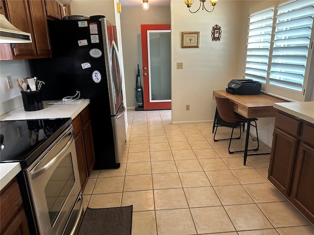 2154 Briarway Dr, Clearwater, FL 33763 - kitchen with stainless steel electric range, light countertops, light tile patterned floors, custom exhaust hood, and a desk