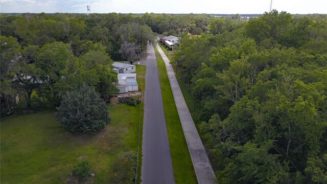 drone / aerial view featuring a forest view