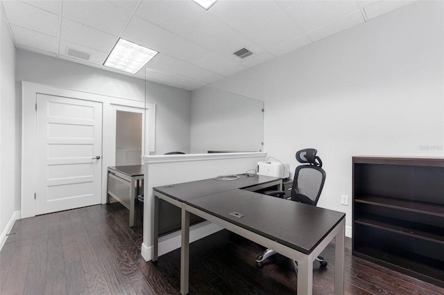 office featuring wood finished floors, visible vents, a paneled ceiling, and baseboards