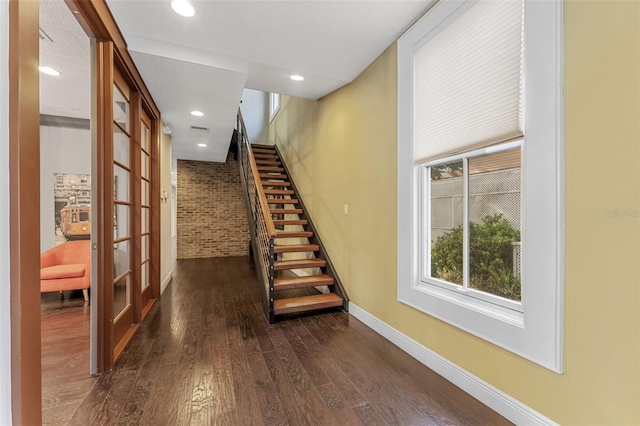 hallway with recessed lighting, dark wood-style flooring, baseboards, stairway, and french doors