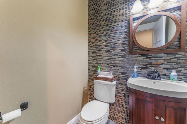 half bath featuring toilet and vanity