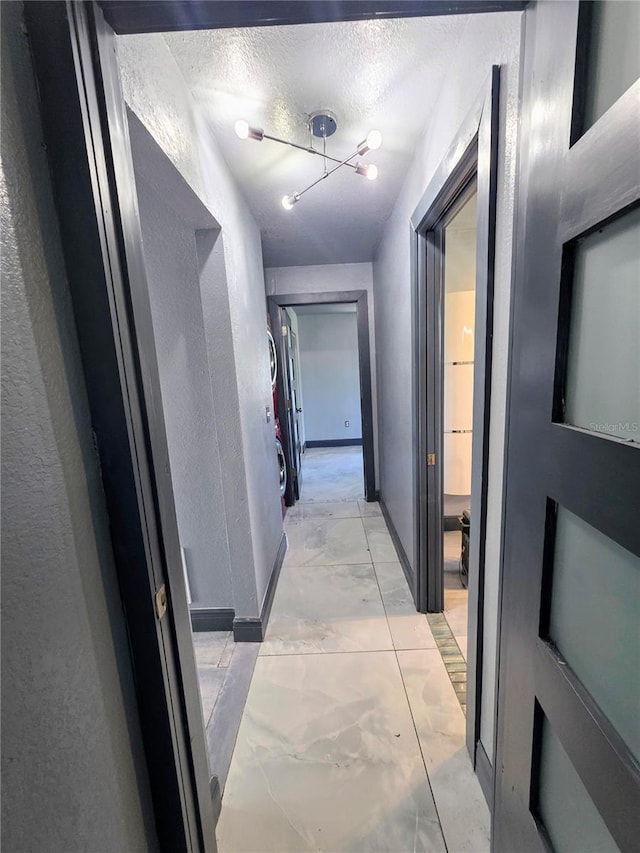 3911 6th Ave W, Palmetto, FL 34221 - corridor featuring light marble finish floors and a textured ceiling