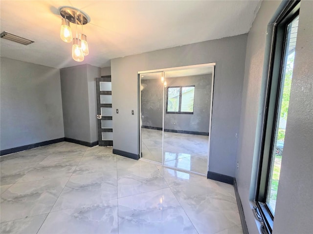 3911 6th Ave W, Palmetto, FL 34221 - empty room with baseboards and light marble finish floors