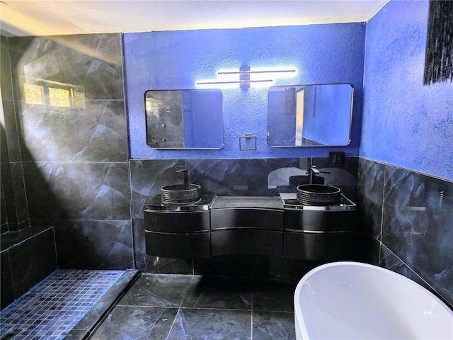 3911 6th Ave W, Palmetto, FL 34221 - bathroom featuring a textured wall, double vanity, a soaking tub, tile walls, and tiled shower