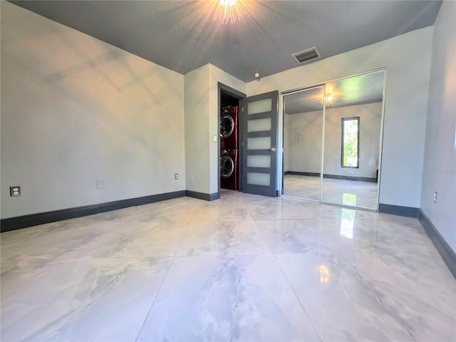 3911 6th Ave W, Palmetto, FL 34221 - spare room with estacked washer and dryer and marble finish floors