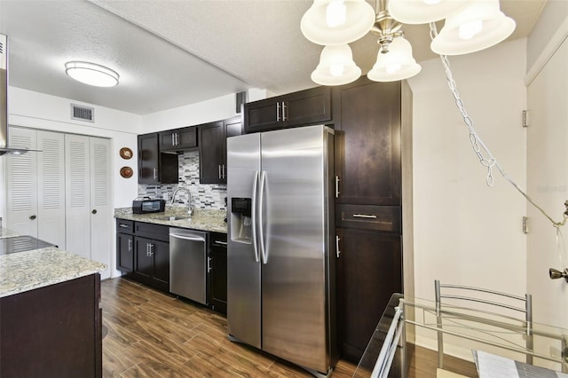 1235 S Highland Ave Unit 2-207, Clearwater, FL 33756 - kitchen with stainless steel appliances, a sink, dark wood-style flooring, decorative backsplash, and light stone counters