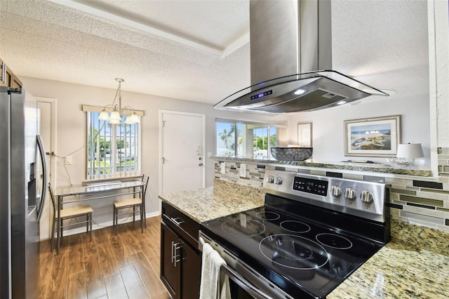 1235 S Highland Ave Unit 2-207, Clearwater, FL 33756 - kitchen featuring appliances with stainless steel finishes, island range hood, decorative backsplash, a chandelier, and dark wood-type flooring