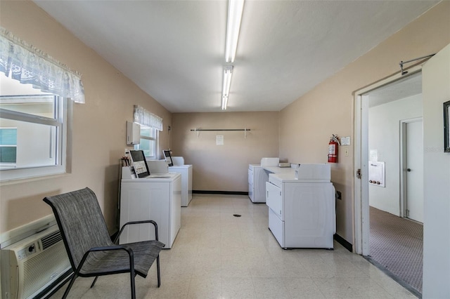 1235 S Highland Ave Unit 2-207, Clearwater, FL 33756 - communal laundry room with separate washer and dryer, a wall unit AC, light floors, and baseboards